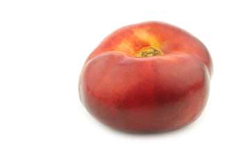 fresh and juicy wild flat nectarine on a white background