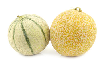 fresh galia melon and a cantaloupe melon on a white background
