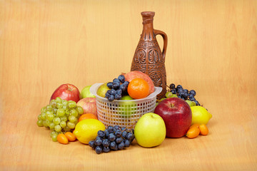 Still life of fruit and ceramic bottle