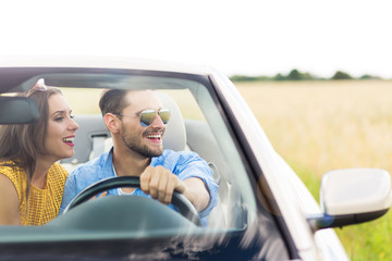 Couple enjoying a drive in a convertible
