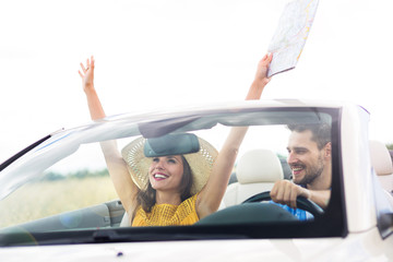 Couple enjoying a drive in a convertible

