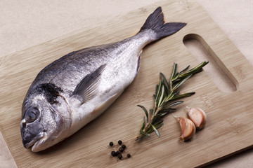 Fresh dorado seafood  on a wooden plank