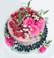 Obraz na płótnie Canvas wedding color drip cake with roses, blueberries and raspberries