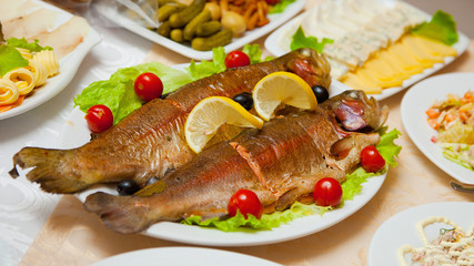 Delicious fried fish on table