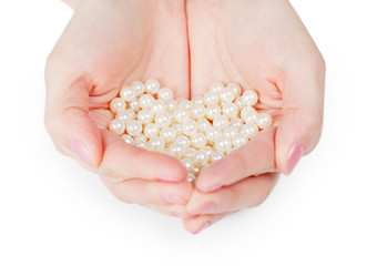 Handful of pearls on white background
