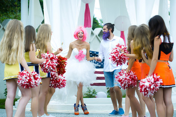 wedding couple with cheerleaders