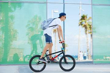 Extreme sport. Healthy active lifestyle concept. Young bike rider wearing sunglasses and snapback...