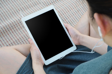 woman listening something from tablet device in relaxing concept.