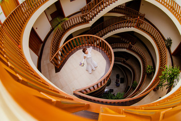 Bride portrait in a spacious room with a beautiful staircase