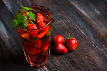 Strawberry mojito cocktail on the wooden background