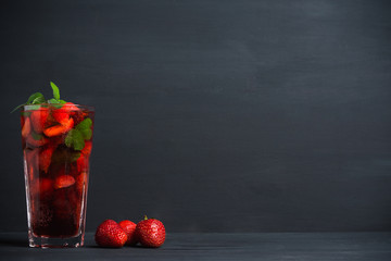 Strawberry mojito cocktail on the wooden background