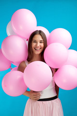 Fototapeta na wymiar Cheerful brunette in balloons