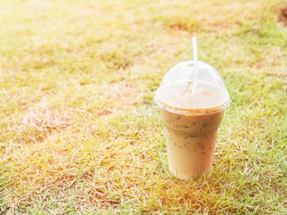 Iced coffee with straw in plastic cup with corlor filter
