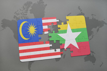 puzzle with the national flag of malaysia and myanmar on a world map background.