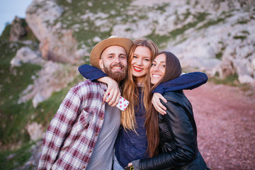 Three friends having fun in a mountain.