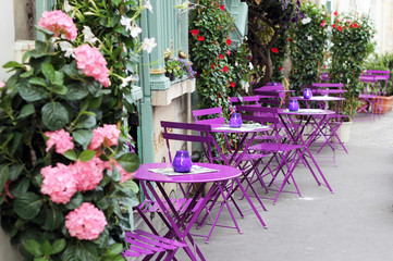 Fototapeta na wymiar Paris street cafe with bright tables.