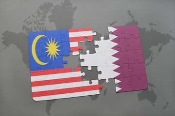 puzzle with the national flag of malaysia and qatar on a world map background.