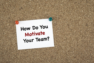 How Do You Motivate Your Team? Sticky note on cork board