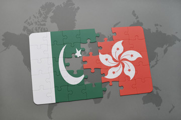 puzzle with the national flag of pakistan and hong kong on a world map background.