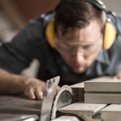 Joiner sawing wood