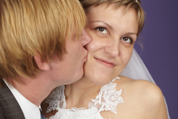 Groom kisses bride