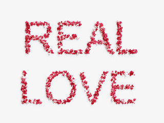 word " REAL LOVE " made of rose petals on white background 3D render.