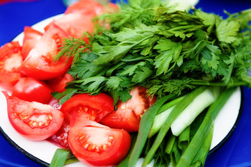 Fresh chopped tomatoes and herbs on a plate