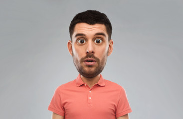 surprised man in polo t-shirt over gray background