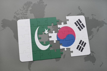 puzzle with the national flag of pakistan and south korea on a world map background.
