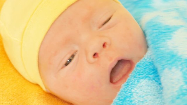 
A newborn baby looks and emotes , 5 day