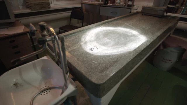 Empty granite table and sink in dead house