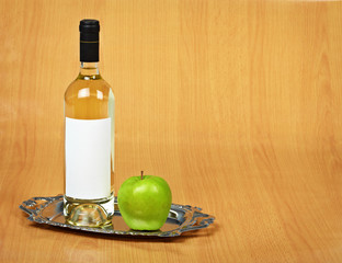Still-life - bottle of white wine and green apple