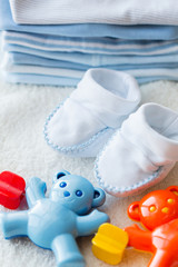 close up of baby rattle and bootees for newborn