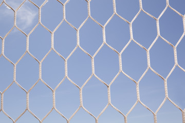 White football, soccer net and blue sky