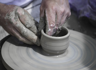 Artisan hands making clay pot