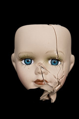 Broken Doll Face and Head on Black Background
