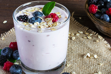 Yogurt with granola or muesli and fresh berries in a glass. heal