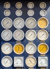 plurality of circular white dials and gauges to measure precise control