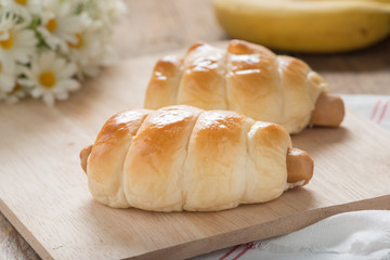 Bread with Sausage on wood board.