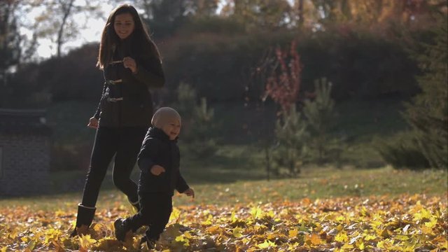 Mom plays with her son and runs after them.