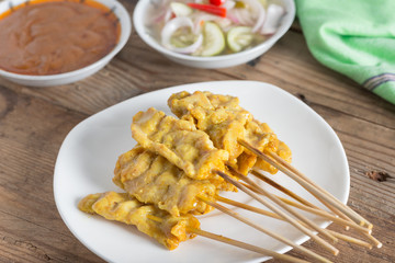 Grilled pork satay with peanut sauce and sour sauce.