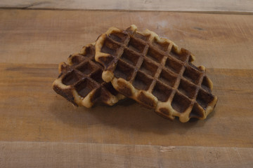 Sweet fresh  belgian waffles on the wood desk.