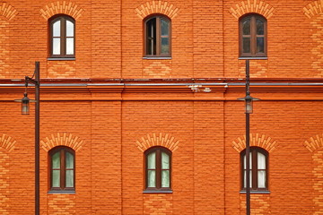 Fototapeta na wymiar Red Brick Wall Facade With Six Arched Windows