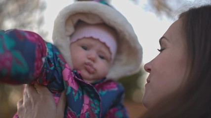 Mom kisses her little daughter.