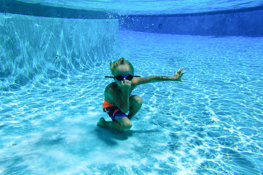 little boy swimming underwater, active kids