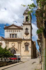 Fototapeta na wymiar Old church and weathered buildings in Old Havana