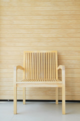 Wooden chair with wooden wall in background