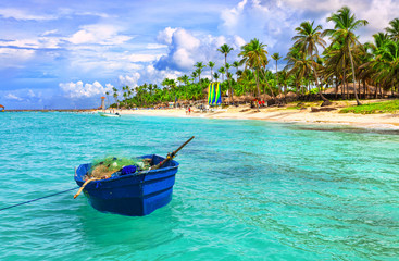 Fishing boat at the sea coast of the Dominican Republic. Blue fishing boat.