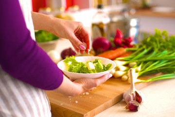 Young Woman Cooking in the kitchen. Healthy Food