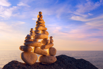 Fototapeta na wymiar Concept of harmony and balance. Rock Zen at sunset.